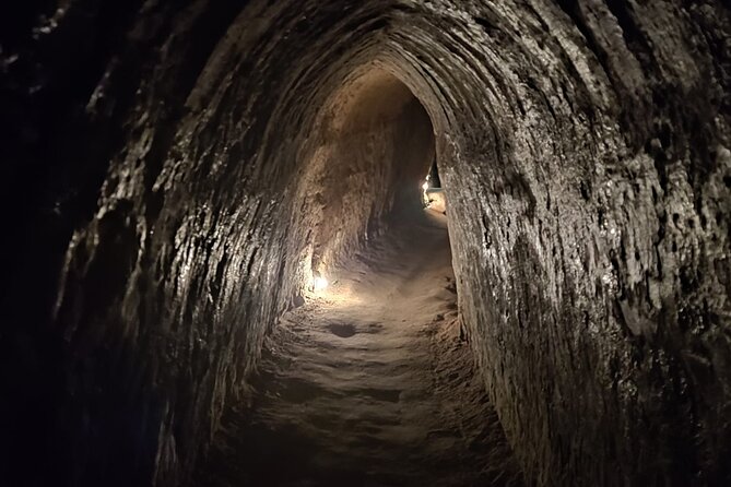 From Ho Chi Minh: Cu Chi Tunnels Half-Day History Tour with Guide - At Cu Chi: documentary, command center, and fighting bunkers