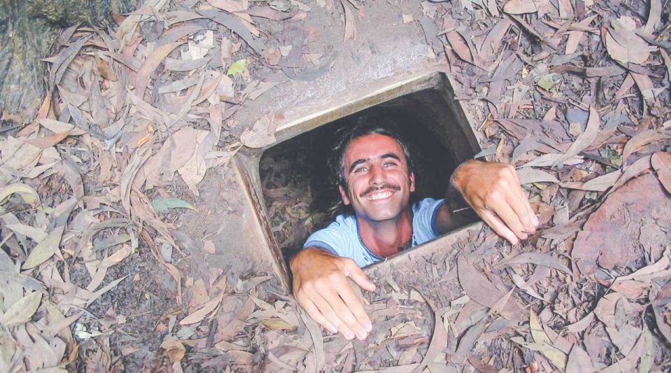 Ho Chi Minh City: Cu Chi Tunnels and Gun Shooting Experience - Inside the Tunnels: Hoang Cam Stove, Underground Kitchen, and Crawl Realities
