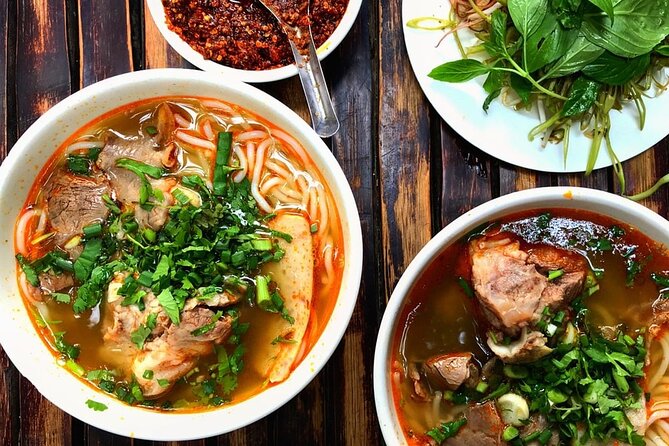 Saigon After Dark With Seafood, Beer & Live Music Bar - Stop 2: Nguyen Thien Thuật apartment buildings and a pagoda inside